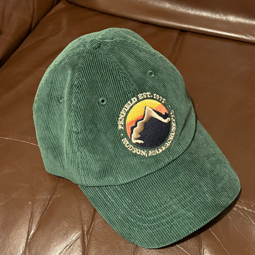 Dark green corduroy hat with embroidered mountain patch